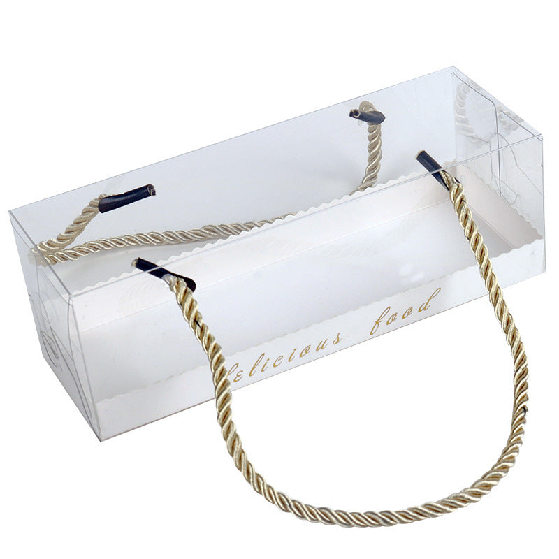 A clear, rectangular plastic box designed to hold baked goods, specifically for Swiss rolls. The box features a decorative golden handle made of twisted rope and has the text "delicious food" printed on one side. The design allows visibility of the contents inside, with rounded edges and a clean, elegant appearance.