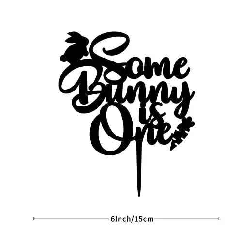A black cake topper designed for a birthday celebration, featuring the phrase "Some Bunny is One" in a playful, cursive font. The topper includes a silhouette of a bunny and a carrot, with the entire design measuring 6 inches in height.
