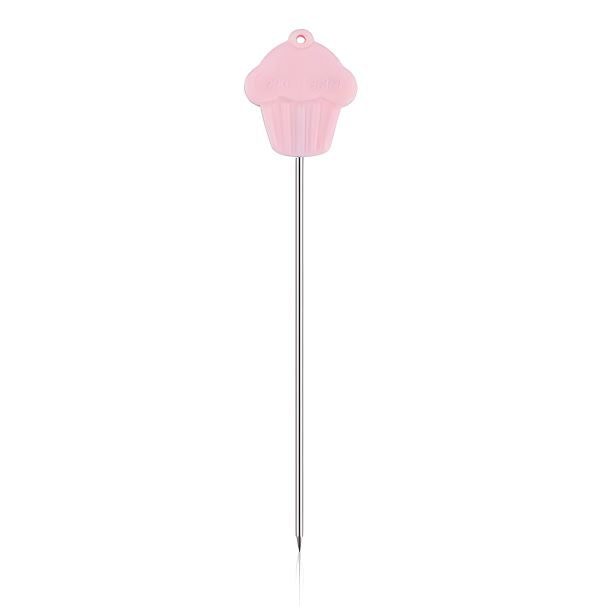 A stainless steel cake tester needle featuring a pink cupcake-shaped handle. The needle is long and slender, made of shiny stainless steel, with a pointed tip for testing baked goods. The cupcake handle adds a playful, decorative touch to the tool.