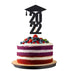 A three-layer cake decorated with vibrant colored layers, including red, purple, and white. The cake is topped with a generous amount of fresh berries, including strawberries, blueberries, and blackberries, along with some green mint leaves. Atop the cake is a black glittery graduation cap and the year "2022" in bold text, marking a graduation celebration. The cake is presented on a round wooden board against a plain white background.