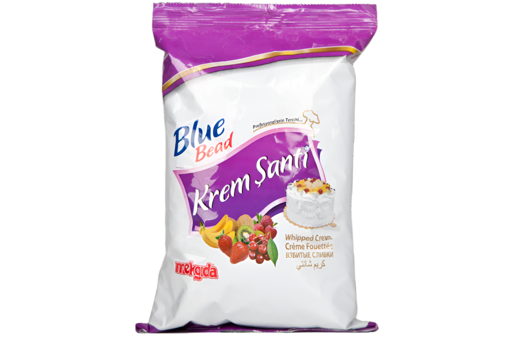 A package of Blue Bead Krem Santi Whip Cream Powder. The packaging is predominantly white with purple accents and features images of a whipped cream-topped cake and various fruits, including bananas, kiwis, strawberries, and cherries. The text on the package includes "Whipped Cream" in multiple languages and the brand name "Blue Bead." The package also has the Mekoda logo at the bottom.