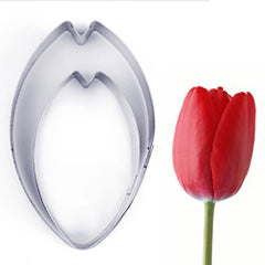 "A tulip petal cutter set of 2 is displayed on the left, featuring two petal-shaped cookie cutters in a light color. On the right, there is a vibrant red tulip flower with a green stem."