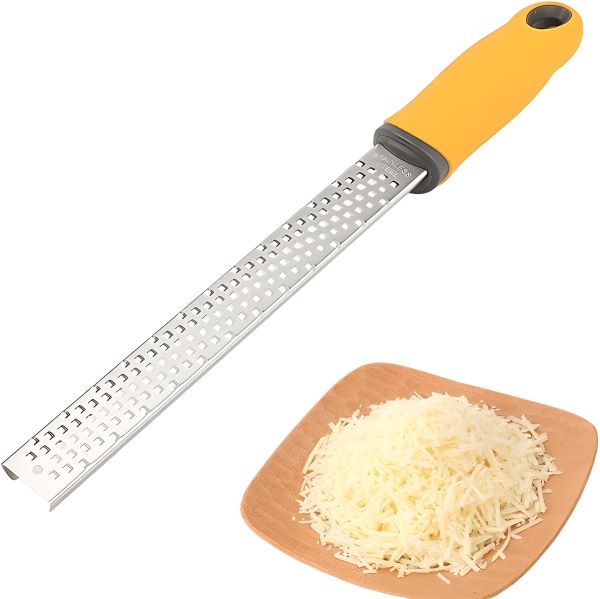 A stainless steel zester with a yellow ergonomic handle, accompanied by a wooden plate containing finely grated cheese, showcasing its effectiveness and design.
