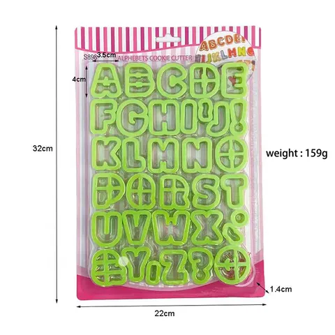 A packaging of green plastic alphabet cookie cutters, featuring letters A to Z, plus symbols such as an exclamation mark and a question mark. The cutters are arranged in a grid on the packaging, which is transparent with a colorful bordered top and includes pink accents. The dimensions listed on the package are 32 cm in height, 22 cm in width, and 1.4 cm in depth, with a weight of 159 grams.