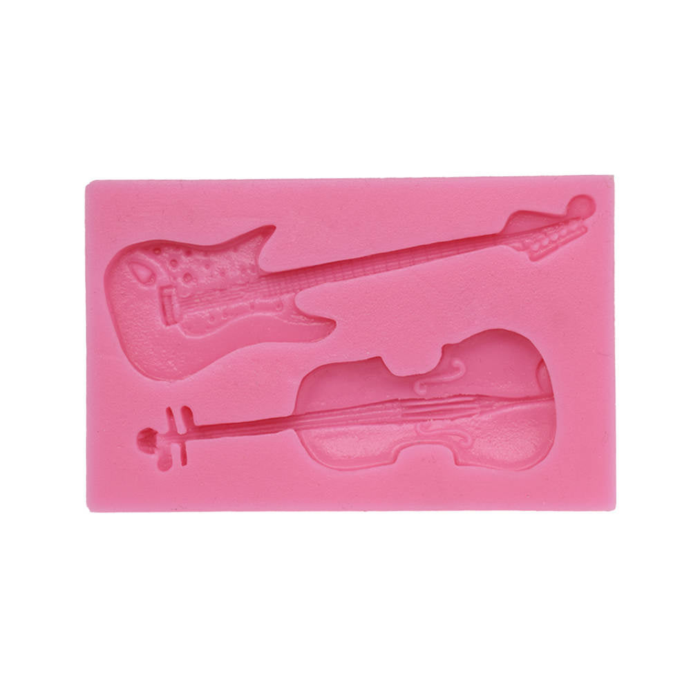 A pink silicone mold featuring two musical instrument shapes: an electric guitar and a violin. The guitar is positioned on the left side of the mold, while the violin is on the right side, both designed with intricate details to capture their features. The mold is flat and rectangular in shape.