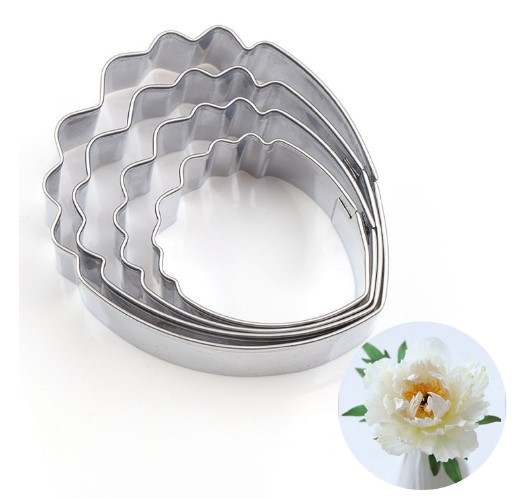 Four metal petal cutters in various sizes, shaped like teardrops with scalloped edges, arranged from largest to smallest. In the bottom right corner, there is a small circular image of a white peony flower with yellow and brown details at the center.