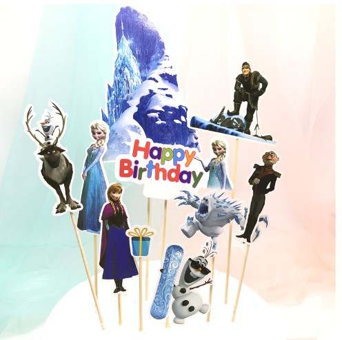 The image features a variety of cake toppers for a birthday celebration, themed around a frozen or winter motif. It includes several character cutouts on sticks, such as a reindeer, two princesses, a snowman, and a male character. There is also a large backdrop of a blue ice mountain and a festive "Happy Birthday" sign in colorful letters, along with a gift box and a snowboard. The background has a soft gradient, enhancing the festive appearance of the product.