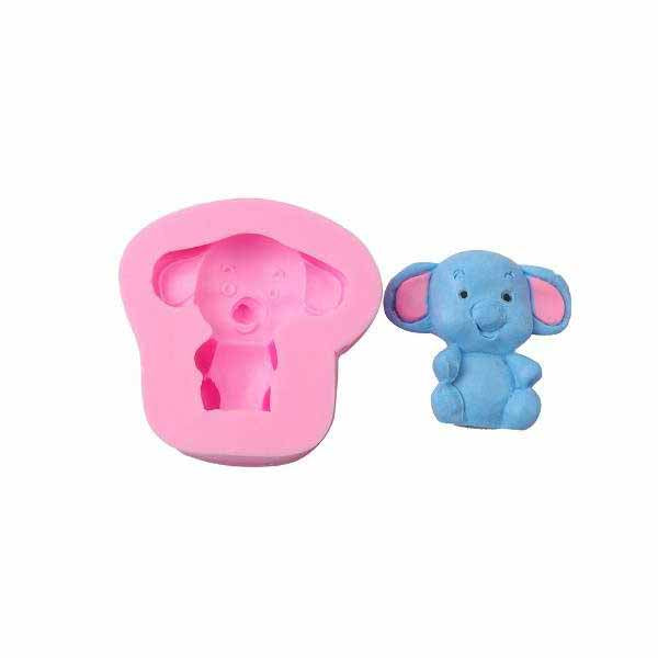 An elephant-shaped silicone mold in pink, accompanied by a completed blue elephant figure that fits the mold. The mold features the textured outline of the elephant, including its large ears and cheerful expression, while the blue figure has detailed features, such as eyes and a smile.