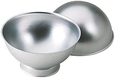 Two metal baking pans designed for making spherical cakes. One pan is a half-sphere shape with a smooth, reflective surface, while the other is a bowl-shaped pan that complements it. Both pans are silver in color and lack any visible handles or decorations.