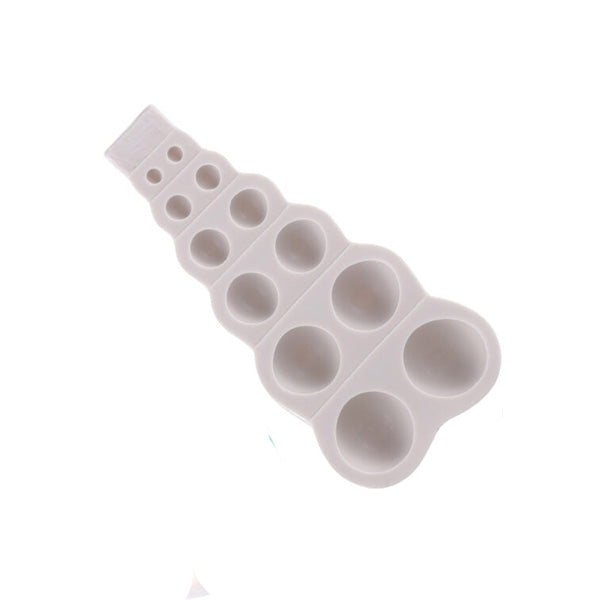 The image shows a silicone mold designed for creating 3D pearl sphere shapes. The mold is white and features a series of six round cavities that progressively increase in size from top to bottom. Each cavity is circular and smooth, suitable for molding beads or spheres. The top part of the mold has a flat edge with a small tab.