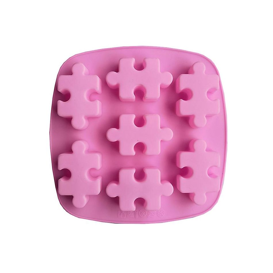 Pink silicone mold with eight puzzle piece shapes. The mold is square with rounded edges, designed for making themed treats or ice cubes.