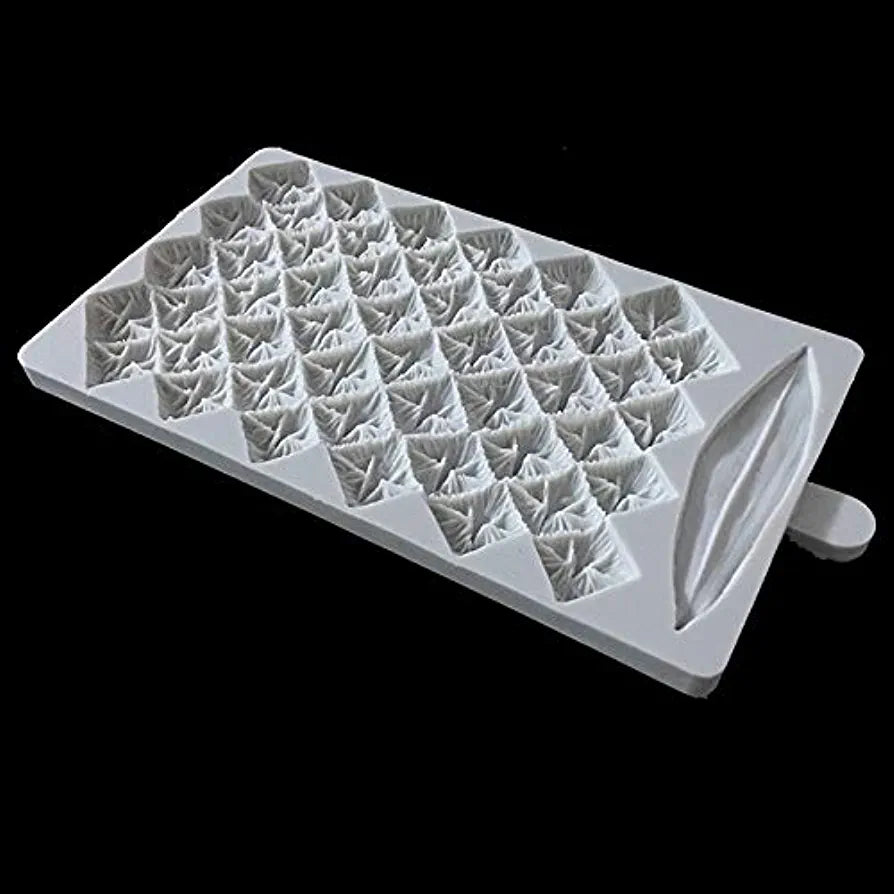 A white silicone mould designed to create pineapple-shaped treats. The mould features a grid of small, raised pineapple designs arranged in a diamond pattern, with a leaf shape on one side. The background is black.