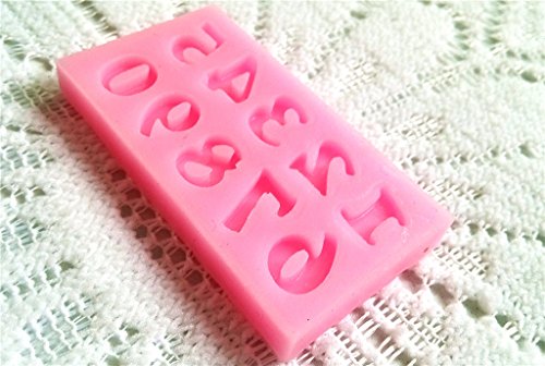 A pink silicone mold featuring various numbers (0-9) in a raised design. The mold is rectangular and has a smooth surface, with each numeral clearly defined and shaped to create impressions for baking or crafting. It is placed on a textured, light-colored fabric background.