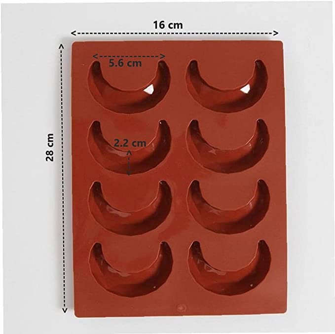 A red silicone mould featuring 8 crescent-shaped cavities arranged in two rows. The mould dimensions are 16 cm in width and 28 cm in height. Each cavity measures approximately 5.6 cm in width and 2.2 cm in depth.