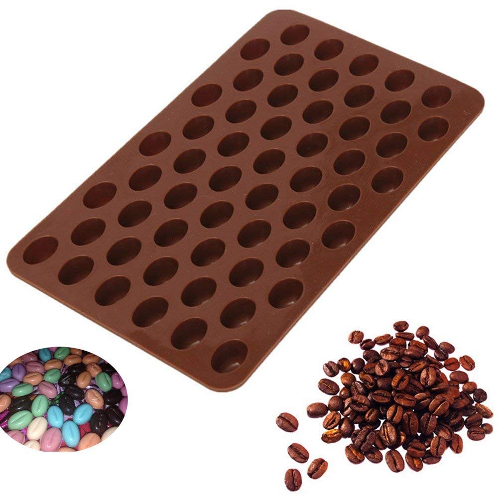 A brown silicone mould designed in the shape of coffee beans, featuring multiple oval-shaped cavities arranged in a grid pattern. To the left, there is a small circular grouping of colorful candy-coated beans in various shades, and to the right, a scattered pile of roasted coffee beans.