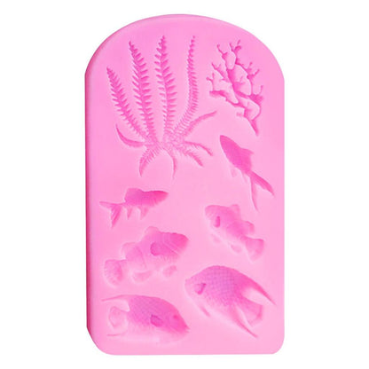 The image shows a pink silicone mould featuring various underwater-themed designs. The mould includes several fish shapes and marine elements such as seaweed and coral. The designs are raised, allowing for detailed impressions. The overall shape of the mould is rectangular with rounded edges.