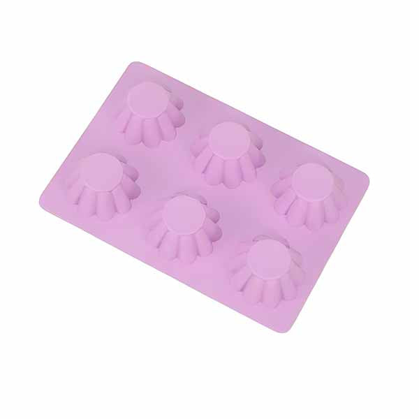 A silicone baking mold in light pink color featuring six cavities shaped like small tarts or fluted cups. The mold is flat and flexible, designed for easy removal of baked goods. Each cavity has a rounded top with decorative ridges, suitable for making individual servings of tarts or desserts.