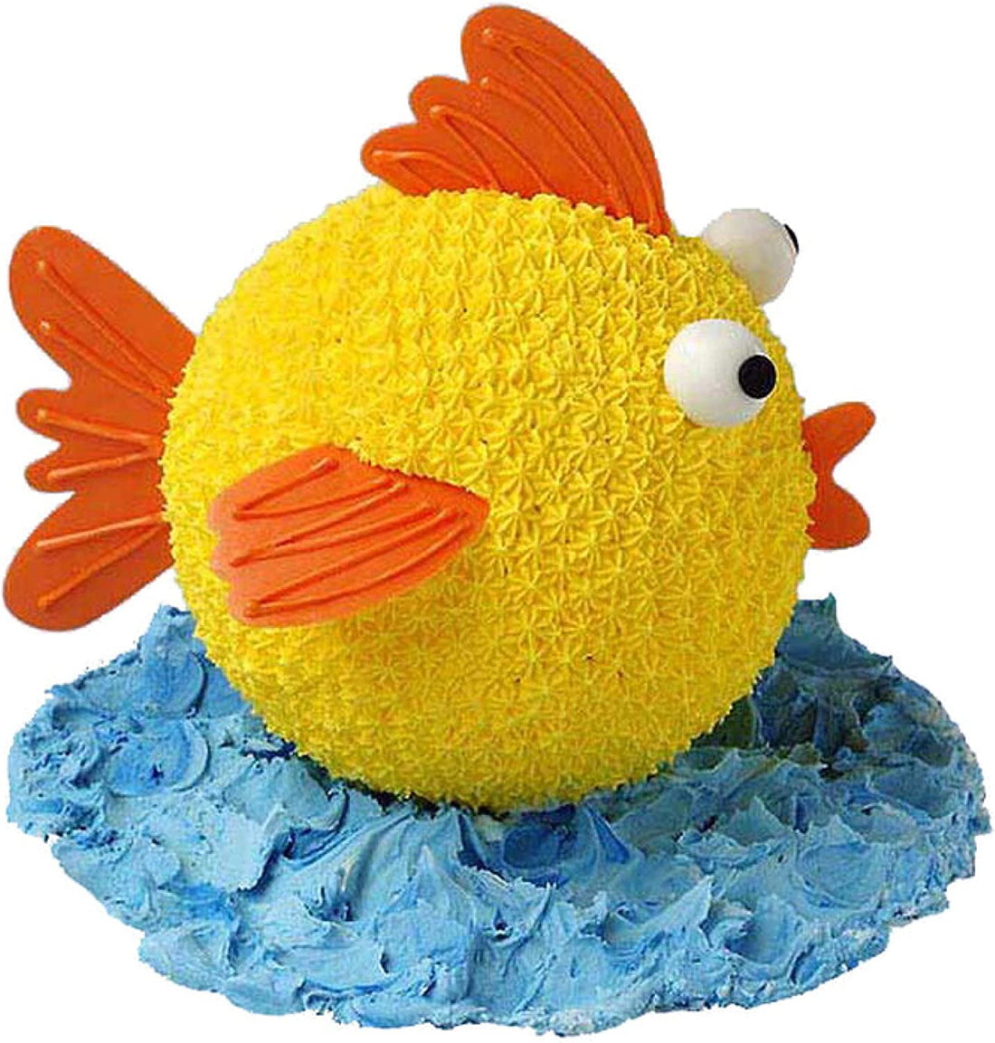 A brightly decorated cake shaped like a yellow fish, featuring textured scales. The fish has large white eyes with black pupils and orange fins. It sits atop a blue frosting base that resembles water waves. The overall appearance is playful and colorful, perfect for a celebration.