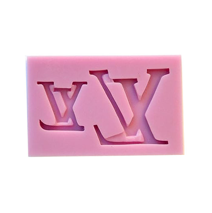 The image features a pink silicone mould shaped like the initials &quot;LV.&quot; The mould has a rectangular form and contains cut-out designs of the letters &quot;L&quot; and &quot;V,&quot; which are stylized and prominently featured. The overall appearance is smooth and flexible, typical of silicone materials used for crafting or baking.