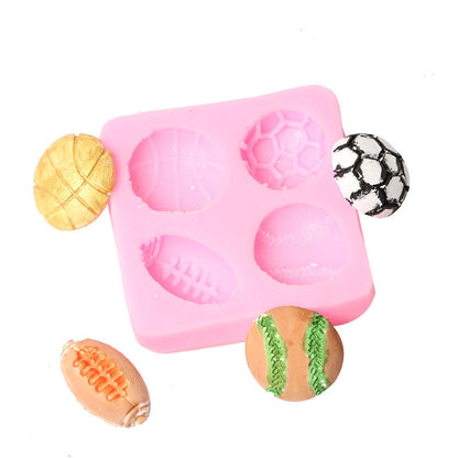 A pink silicone mold designed to create mini ball shapes, featuring six cavities in various sports ball designs. The mold contains five finished mini balls: a golden basketball, a black and white soccer ball, an orange football, a traditional baseball with green stitching, and a classic green and white tennis ball. The mold itself is simple in design, with visible cavity outlines. The arrangement emphasizes the colorful and playful nature of the product.