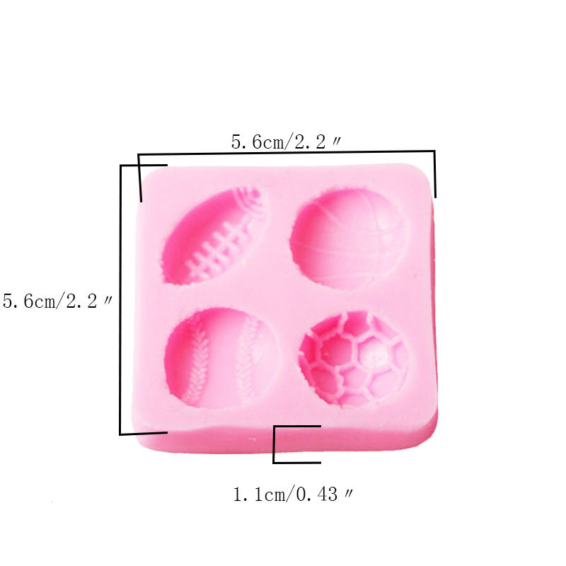 A pink silicone mold featuring four cavities designed in the shapes of various sports balls: a football, a basketball, a baseball, and a soccer ball. The mold measures approximately 5.6 cm (2.2 inches) in width and height, with each cavity having a depth of about 1.1 cm (0.43 inches).