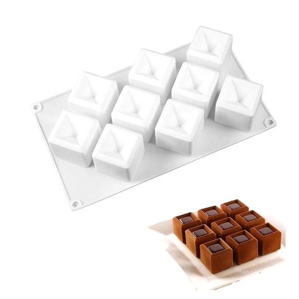 An image featuring a silicone mold designed for making cubes. The mold is white and has nine cavities in the shape of cubes with a concave top. Below the mold, there are brown chocolate or gelatin cubes that have been made using the mold, showcasing their distinct shape with a glossy surface and a darker center. The product is ideal for creating unique dessert shapes.