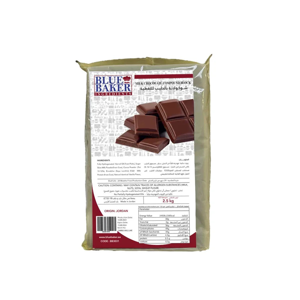 The image shows a 2.5 kg block of milk chocolate compound from the brand "Blue Baker." The packaging is primarily beige, featuring an illustration of several chocolate squares on the front. The product information is printed on the back, including the ingredients list, nutritional information, and allergen warnings in both English and Arabic. The origin of the product is indicated as Jordan. The package also displays the brand&
