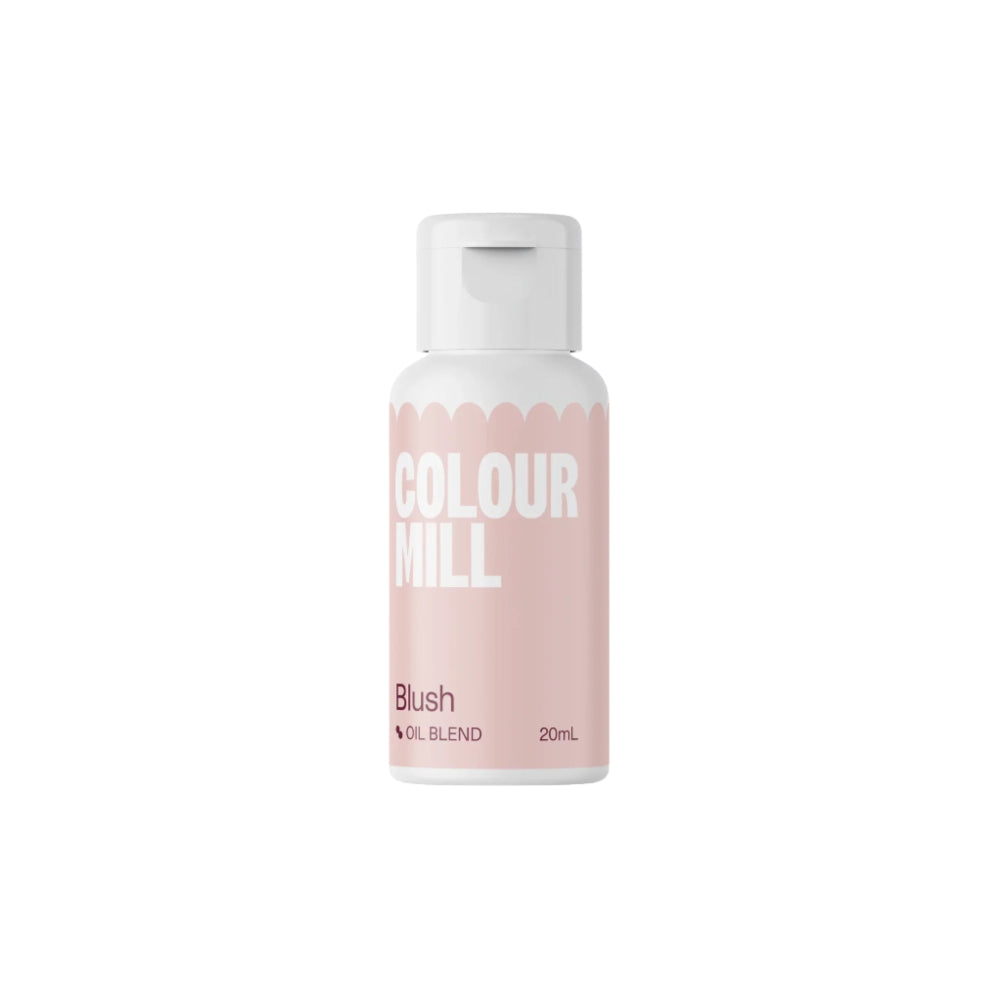 The image features a bottle of "Colour Mill" oil-based food color, specifically in the shade "Blush." The bottle design is sleek with a light pink label, and bold white text displaying the brand name "COLOUR MILL" and the product type "Blush" along with "Oil Blend" and the volume "20ml." The cap is white, matching the overall modern aesthetic of the product. The background is plain, enhancing visibility of the bottle.