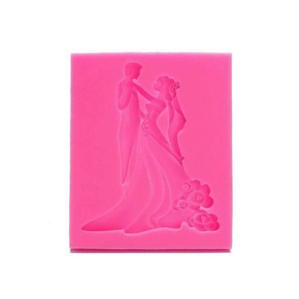 A pink silicone mold depicting a bride and groom dancing. The mold features detailed figures of the couple, with the bride wearing a flowing gown and the groom in a suit. The design includes decorative elements, such as flowers, enhancing the romantic theme.