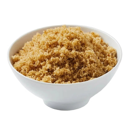Brown sugar piled in a white ceramic bowl on a clean white background.