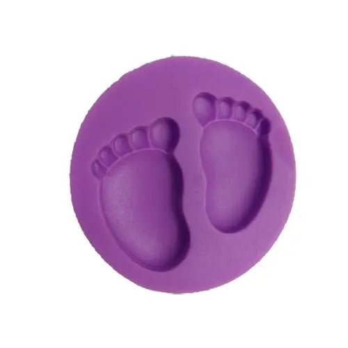 A circular silicone mold in purple featuring an imprint of two baby footprints, including detailed toes and rounded soles.