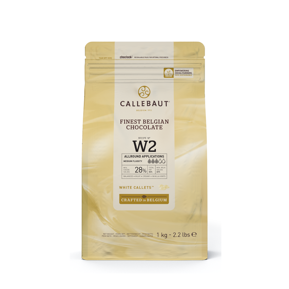 A bag of Callebaut Finest Belgian Chocolate, Recipe No. W2, featuring white callets with 28% cocoa content. The packaging indicates its use for all-round applications with medium fluidity, crafted in Belgium. The bag weighs 1 kg (2.2 lbs).