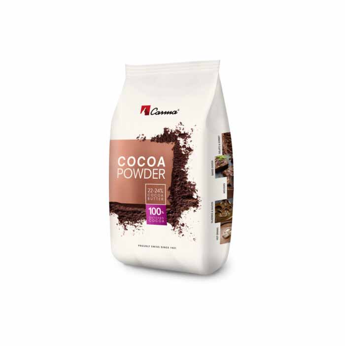 A white bag of Carma cocoa powder weighing 1 kg. The front features the text &quot;COCOA POWDER&quot; prominently displayed in large letters, along with information about the cocoa content (22-24% cocoa butter) and a note indicating it is made from 100% pure cocoa. There are images of chocolate desserts beside the text, enhancing its appeal for baking or cooking. The bag is designed in a clean and modern style.