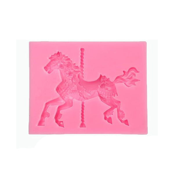A pink silicone mould shaped like a carousel horse, featuring intricate detailing of the horse and a central post. The horse is in a dynamic pose, with decorative elements visible on its body and a flowing mane.