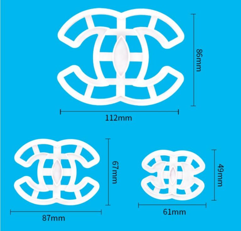 The image features a set of three white plastic cookie cutters shaped like a stylized logo. The cookie cutters are displayed on a bright blue background, showcasing their various sizes. The largest cutter measures 112mm by 86mm, the medium one is 87mm by 67mm, and the smallest is 61mm by 49mm. Each cutter has a similar design, featuring an open pattern that outlines the logo shape.