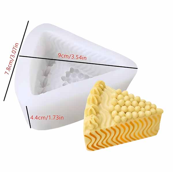 A triangular silicone mold designed for making cheese-shaped items. The mold is white with textured details inside and is shown next to a cheese-shaped item that is yellow and features decorative elements, including small spheres and zigzag patterns. Dimensions of the mold are included: height 7.8 cm (3.07 in), width 9 cm (3.54 in), and depth 4.4 cm (1.73 in).