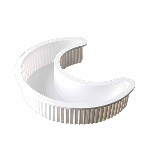 A white silicone mold in the shape of a crescent moon, featuring a smooth, rounded outer edge and a ribbed texture on the inner walls. The mold has a semi-circular design, suitable for baking or crafting.