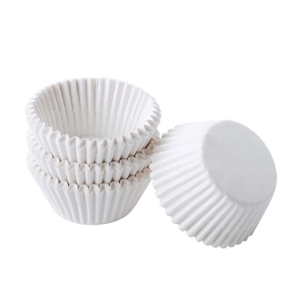 Four white cupcake liners are stacked, with three liners upright and one on its side. The liners have a ridged texture and a smooth base, suitable for baking cupcakes. This image represents a product offering 100 pieces of white cupcake liners.