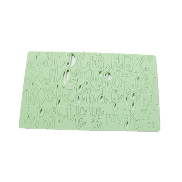 A mint green acrylic cake stamp featuring uppercase and lowercase letters of the alphabet, with each letter intricately cut out for stamping purposes. The stamp includes all 26 letters from A to Z in a decorative handwritten style.