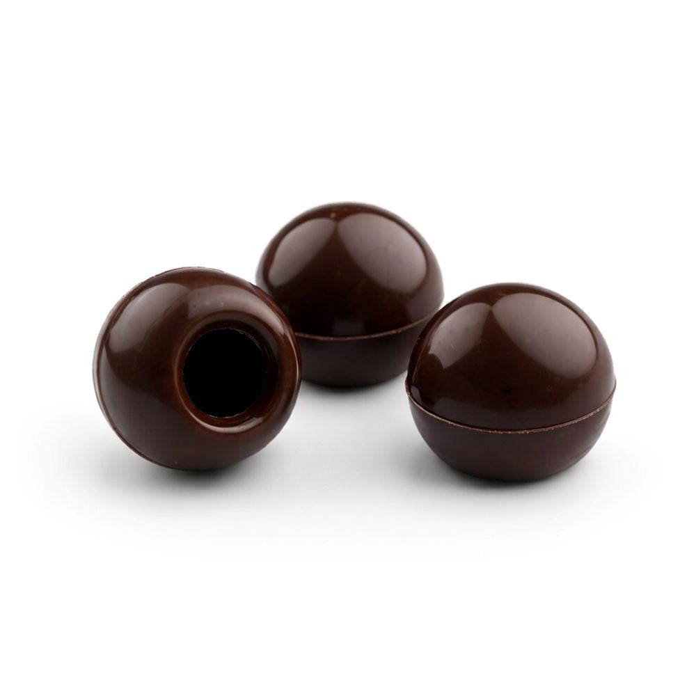 Three Darrk chocolate truffles on a white background