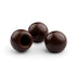Three Darrk chocolate truffles on a white background