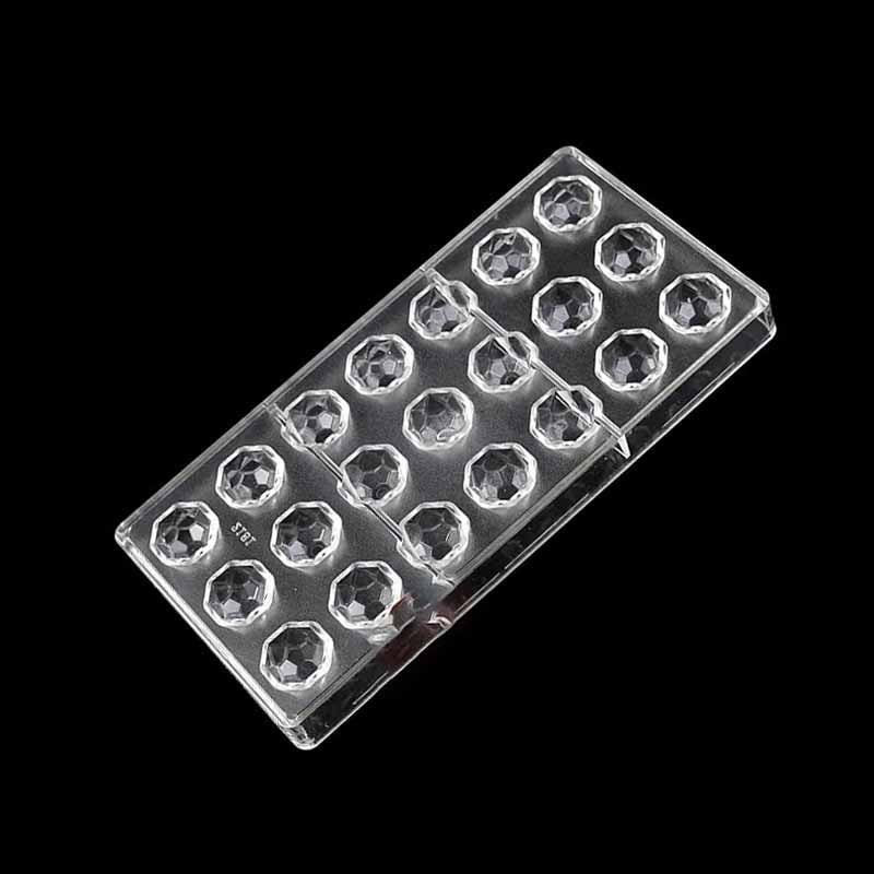 A clear plastic chocolate mold featuring a diamond shape design, consisting of 24 individual cavities arranged in four rows. The mold is placed on a black background.