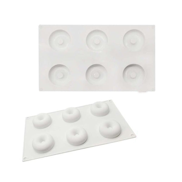 Two white silicone donut molds, each with six circular cavities for shaping donuts. The molds are shown stacked, with the top mold featuring deeper cavities and the bottom mold displaying slightly shallower ones.