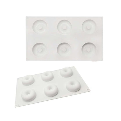 Two white silicone donut molds, each with six circular cavities for shaping donuts. The molds are shown stacked, with the top mold featuring deeper cavities and the bottom mold displaying slightly shallower ones.