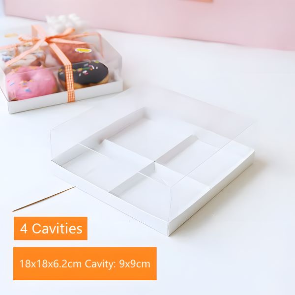 The image features a white pastry box designed to hold four portions, which has a clear lid. The box is shown from a slightly angled perspective, revealing its compartments. There is an orange label on the box indicating &quot;4 Cavities,&quot; alongside specifications: &quot;18x18x6.2cm,&quot; with each cavity measuring &quot;9x9cm.&quot; In the background, there is another box containing donuts, tied with an orange ribbon. The overall aesthetic is bright and inviting, suitable for showcasing pastries.