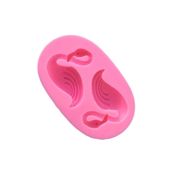 "A pink silicone mould shaped like flamingos, featuring two flamingo designs with details for wings and heads in an oval shape."