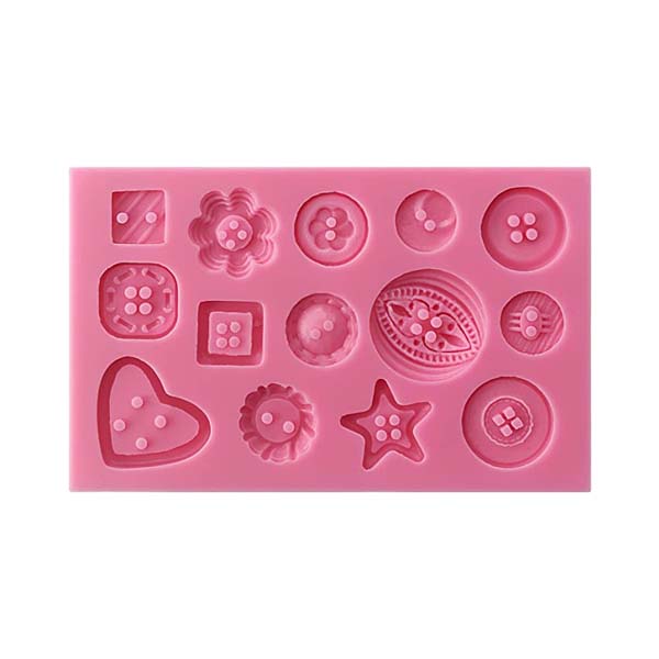A pink silicone mould featuring various decorative button shapes. The mould includes multiple designs such as round buttons, square buttons, a flower shape, a heart shape, a star shape, and other stylized button patterns, all with raised details. The overall arrangement is organized neatly on a rectangular base.