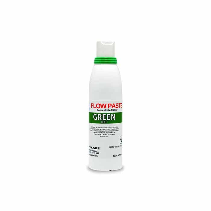 A 4-ounce bottle of Kopykake Flow Paste in green. The cylindrical bottle has a white body with a green cap and features red and green text. The label states &quot;FLOW PASTE&quot; in red, &quot;Concentrated Kolor&quot; in smaller text, and &quot;GREEN&quot; along with &quot;LEAF&quot; in green. The bottle is designed for use in cake decorating and other food applications.