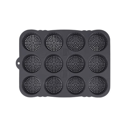 A black muffin pan featuring multiple holes for baking individual muffins or cupcakes.