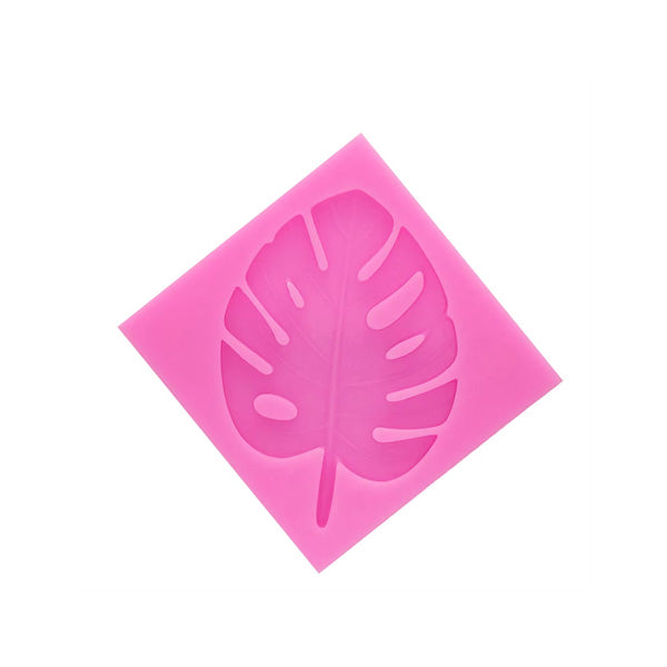 A pink silicone mold shaped like a tropical leaf, featuring detailed cutouts of the leaf&